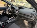 Interior view of a 2021 Subaru WRX showing the dashboard steering wheel gear shifter and front seats
