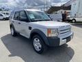 A silver 2006 Land Rover LR3 with rounded edges and large wheels positioned at an angle facing slightly to the left