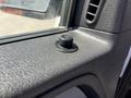 Close-up of a textured black plastic interior panel in a 2014 Ford F-150 featuring a circular dial and a vent opening