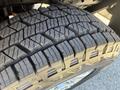 Close-up of a sturdy tire with deep treads designed for rugged terrain on a 2014 Ford F-250 SD