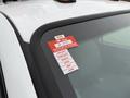 2001 Ford F-350 with a red certificate of approval sticker attached to the windshield displaying the year and months listed