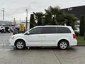 A white 2017 Dodge Grand Caravan parked at an angle with tinted windows and alloy wheels