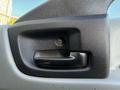 Black door handle of a 2014 Hino 195 mounted on a gray panel