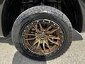 A 2019 RAM 1500 wheel featuring a bronze five-spoke rim and a black Gladiator tire with an aggressive tread pattern