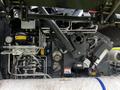 A 2020 Pottinger Impress machine showcasing various hydraulic components and pipes in intricate arrangement for agricultural use
