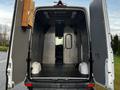 Interior of a 2017 Mercedes-Benz Sprinter van showing open back doors with a spacious cargo area and a partition to the driver's compartment