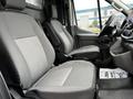 Two gray fabric front seats inside a 2020 Ford Transit van with a black dashboard and steering wheel visible