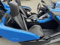 A 2020 Polaris Slingshot interior featuring two sporty black seats with a central console and various controls in a blue and black design