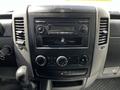 Dashboard of a 2012 Mercedes-Benz Sprinter featuring a radio unit and climate control knobs