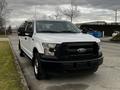 A white 2016 Ford F-150 pickup truck facing the camera with a black grille and fog lights