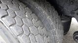 Close-up of a tire from a 2012 International 7400 showing tread patterns and wear on the rubber surface