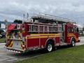 A red 2009 Spartan Gladiator fire truck with a ladder on top and various emergency equipment visible on the sides