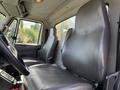 Interior view of a 2013 International 7400 showing two gray leather seats designed for a commercial truck