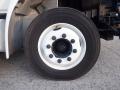 A close-up of a wheel from a 2014 International Durastar featuring a white rim and black tire with visible lug nuts