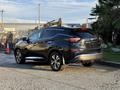 A black 2021 Nissan Murano parked with a sleek design featuring prominent curves and a distinctive rear light design