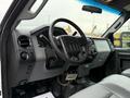 Interior view of a 2013 Ford F-550 showing the steering wheel and dashboard with controls and a gear shift