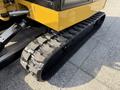 Close-up of a 2022 Caterpillar 306 excavator's rubber track featuring a textured surface designed for improved traction and stability
