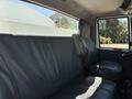 Interior view of a 2008 International DuraStar truck showing a black leather seating area with a single seat and safety belt visible
