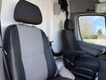 Interior view of a 2016 Mercedes-Benz Sprinter showing two black and grey upholstered front seats with headrests and armrests