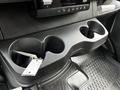 A black plastic cup holder insert from a 2019 Mercedes-Benz Sprinter with three compartments and a keychain hanging from one of the slots