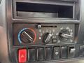Control panel of a 2018 Hino 195 featuring knobs for air conditioning and ventilation with buttons for hazard lights and other controls