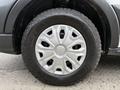 Close-up of a 2023 Ford Transit wheel featuring a silver-colored hubcap with a distinct design and a Goodyear Wrangler tire showcasing rugged tread patterns