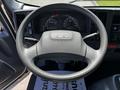 Steering wheel and dashboard of a 2016 Isuzu NPR displaying gauges and controls