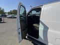 A 2016 GMC Savana with the driver's side door open revealing the interior and driver's seat