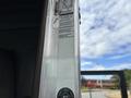 A 2013 Kenworth T370 truck door with visible manufacturer labels and a logo near the handle