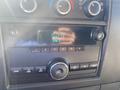 Dashboard of a 2012 GMC Savana with a radio display showing the time 5:24 and FM station indicator along with climate control dials and audio controls