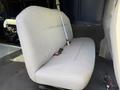 A gray upholstered bench seat from a 2011 Ford Econoline van with a seatbelt and a sturdy base