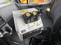 A control panel with multiple levers and gauges inside a 2016 Freightliner 108SD truck cab