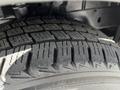 Close-up of a winter tire mounted on a 2015 Ford Transit showcasing detailed tread patterns designed for traction and grip on snowy surfaces