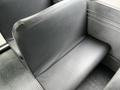 A worn black bus seat from a 2015 Spartan School Bus