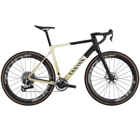 2025 Canyon Grail CFR XPLR road bike with a sleek design featuring a black and cream frame disc brakes and high-performance wheels
