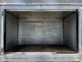 An empty metal cargo space of a 2008 Morgan Olson Workhorse with aluminum walls and a wooden floor