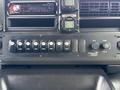 Dashboard controls and gauges of a 2013 Chevrolet Express including buttons for various functions and displays for fan and temperature settings