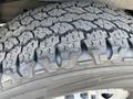 Close-up of a tire tread of a 2016 GMC Savana showcasing its deep grooves and textured rubber surface