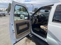 A 2014 Ford F-350 SD with an open door revealing the interior including the steering wheel and dashboard