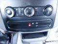 Close-up view of the control panel in a 2016 Mercedes-Benz Sprinter featuring knobs and buttons for climate control and hazard lights
