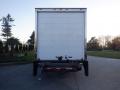 A white 2014 International Durastar box truck from the rear with a loading ramp extended and no visible branding or markings