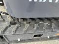 Close-up of a 2024 AGT Mini Excavator's track and undercarriage detailing the tread pattern and components