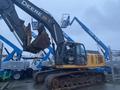 A 2014 John Deere 350G excavator with a large bucket attached and tracks for movement