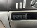 Close-up view of the control panel inside a 2007 Ford F-550 featuring labeled switches for auxiliary functions and a dial for adjusting rear flood lights