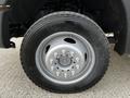 A close-up of a silver wheel with a five-spoke design mounted on a tire labeled 225 FOR R19.5 designed for a 2016 Ford F-550
