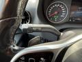 A close-up view of the steering wheel and dashboard controls of a 2019 Mercedes-Benz Sprinter showcasing the speedometer and various instrument panel indicators