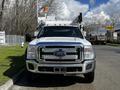 A 2016 Ford F-550 truck with a white exterior and multiple front lights positioned for utility work
