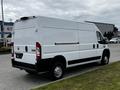 A white 2021 RAM Promaster van parked with a high roof and sliding side door
