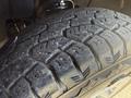 Close-up of a treaded tire from a 2016 GMC Sierra 1500 showcasing deep grooves and rugged design for traction