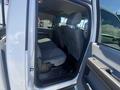 Interior view of a 2016 Ford F-350 SD showing the rear seats and door trim with a gray upholstery design
